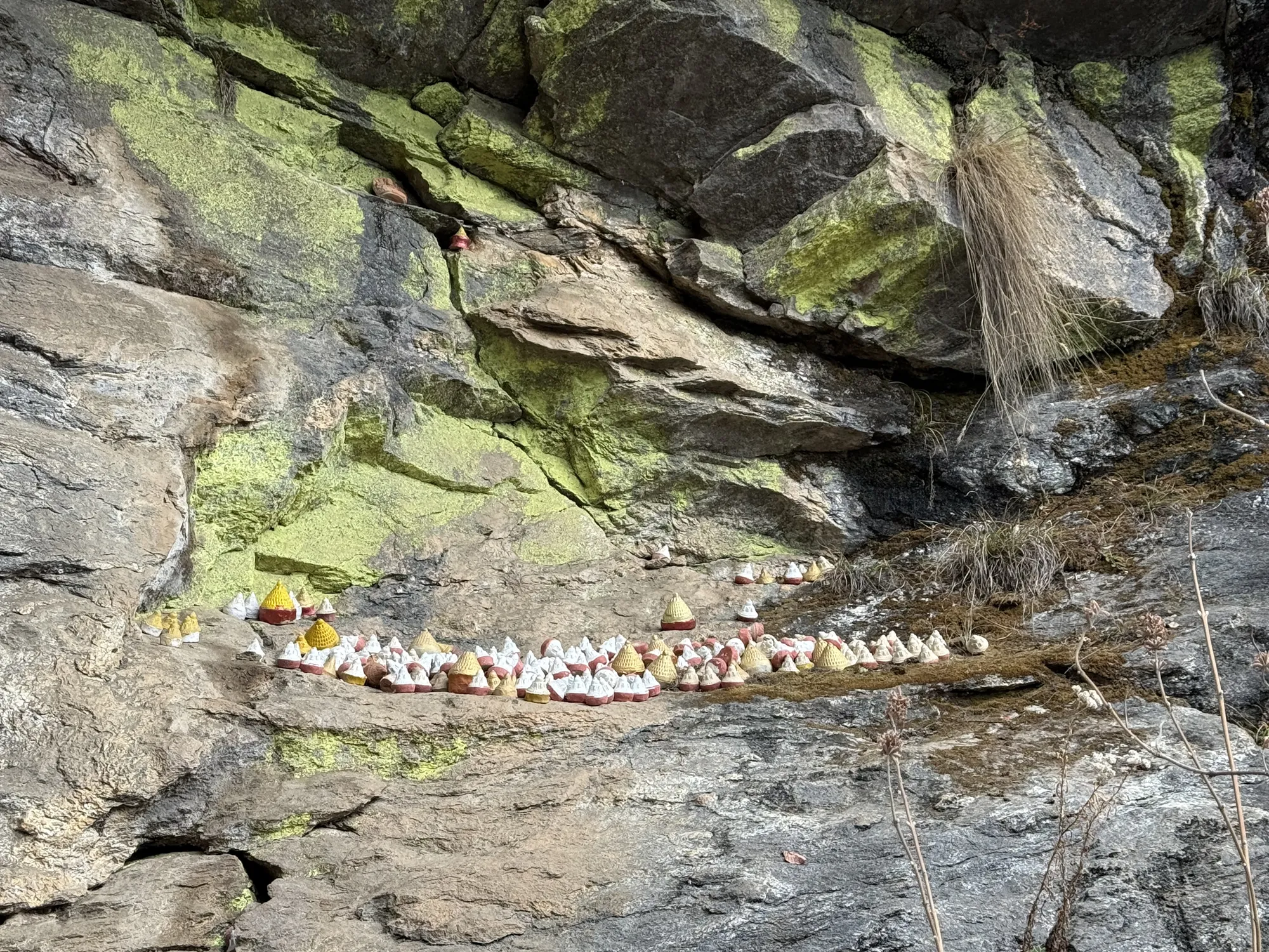 Votive offerings set along a cliff face