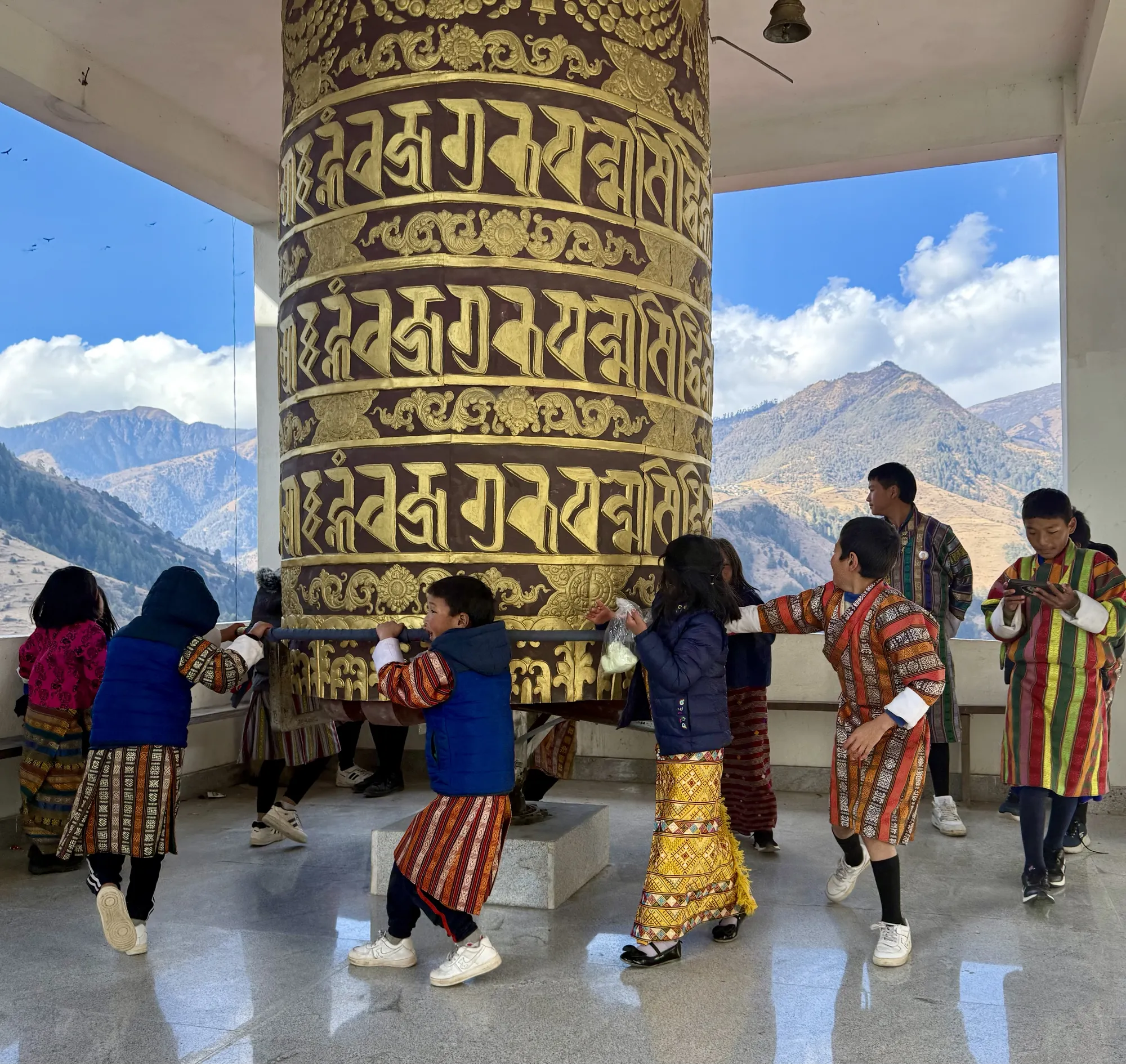 Pilgrims turning a great prayer wheel