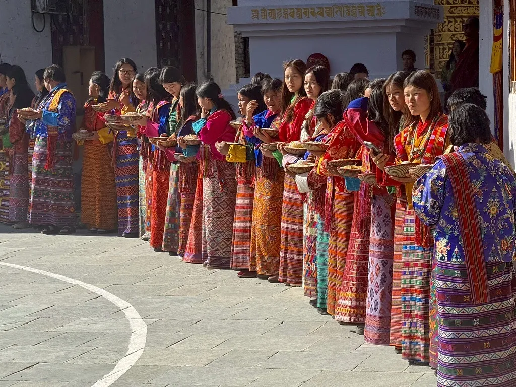 A receiving line of women in traditional kira